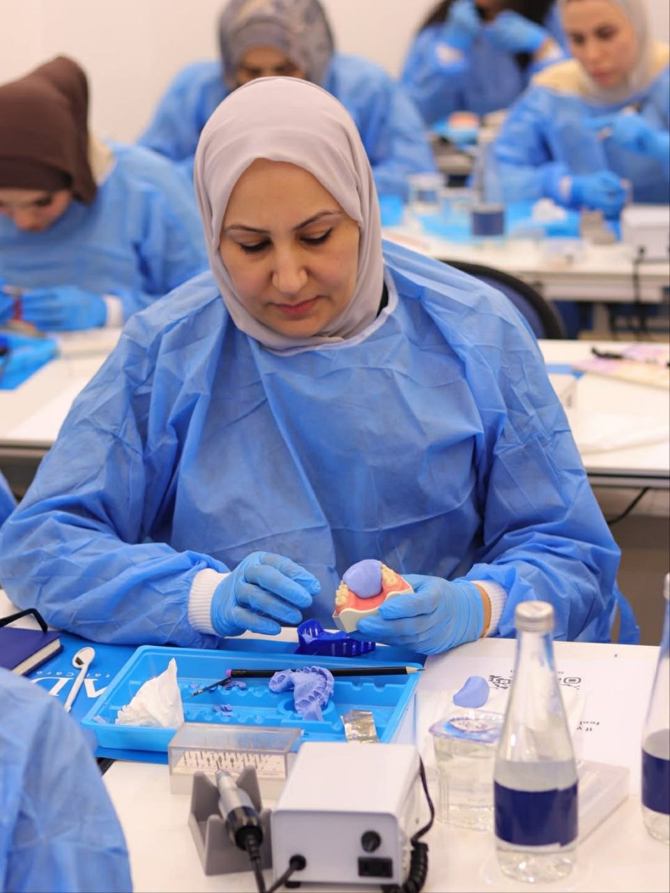 A course attendee working on a model at the bench
